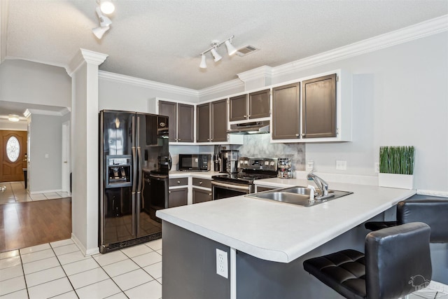 kitchen featuring black appliances, kitchen peninsula, sink, crown molding, and light tile patterned floors