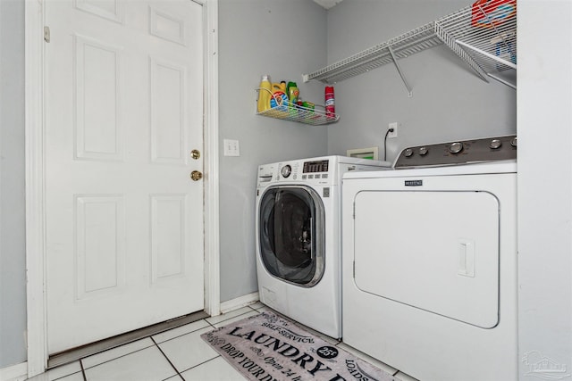 washroom with light tile patterned flooring and separate washer and dryer