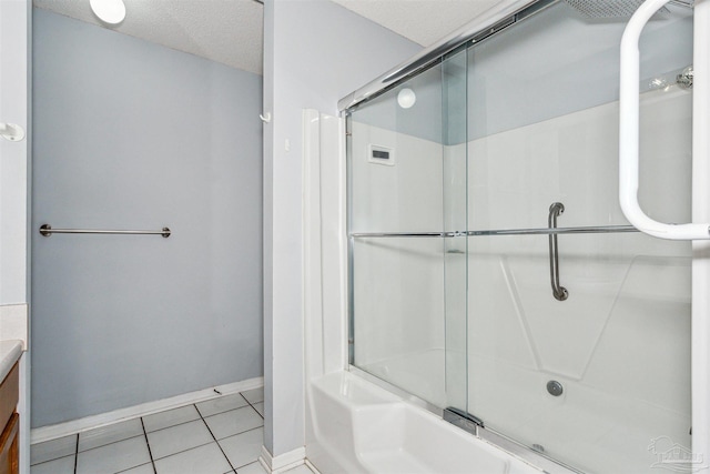 bathroom with a textured ceiling, tile patterned floors, vanity, and enclosed tub / shower combo