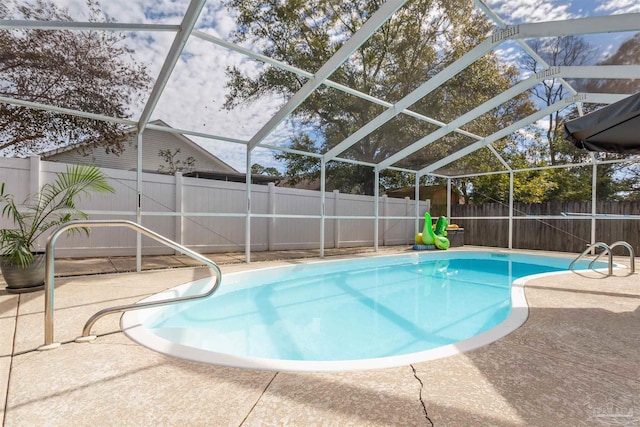 view of pool with a patio area and a lanai