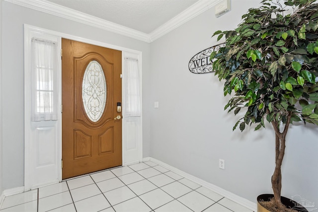 tiled entrance foyer with crown molding and a textured ceiling