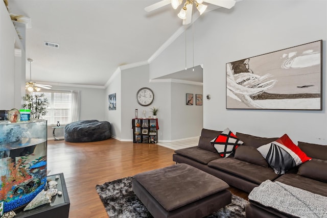 living room featuring ceiling fan, hardwood / wood-style floors, and vaulted ceiling