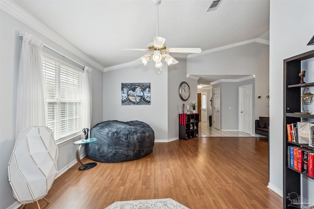 sitting room with ceiling fan, ornamental molding, lofted ceiling, and light hardwood / wood-style flooring