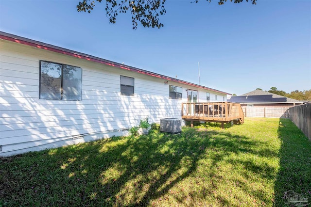 rear view of house featuring central AC, a yard, and a deck