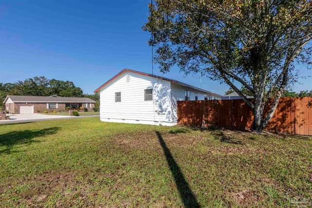 view of side of property with a yard