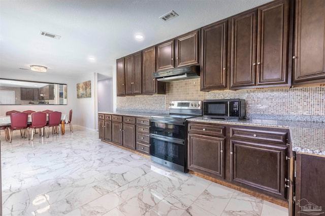 kitchen with dark brown cabinets, decorative backsplash, appliances with stainless steel finishes, and light stone countertops