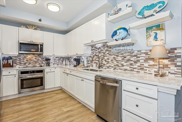 13599 Perdido Key Dr Unit T-2C, Perdido Key, FL 32507 - kitchen with stainless steel appliances, open shelves, light countertops, and tasteful backsplash