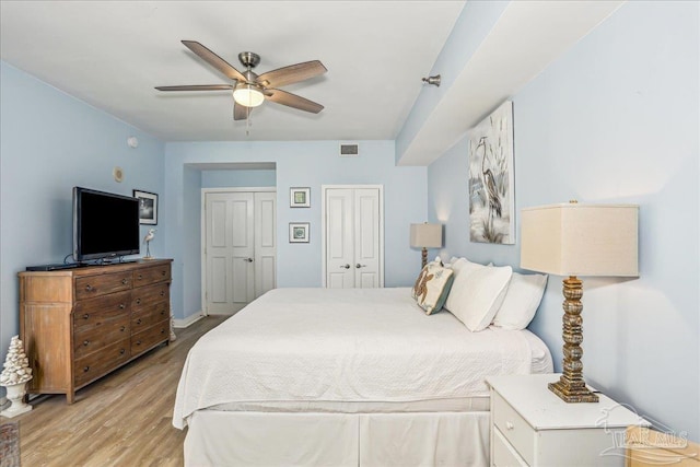 13599 Perdido Key Dr Unit T-2C, Perdido Key, FL 32507 - bedroom featuring multiple closets, light wood-style flooring, and a ceiling fan