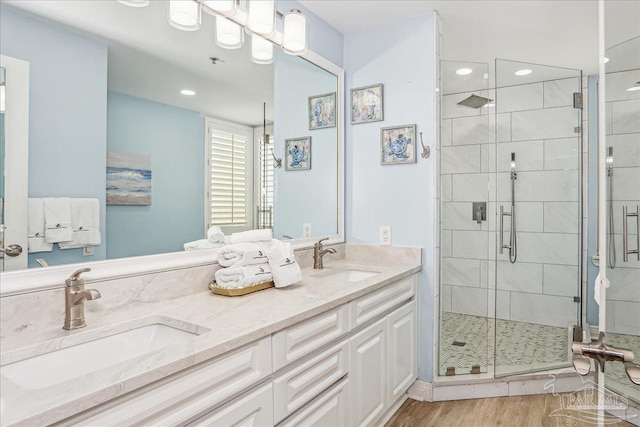 13599 Perdido Key Dr Unit T-2C, Perdido Key, FL 32507 - full bathroom with a shower stall, double vanity, wood finished floors, and recessed lighting