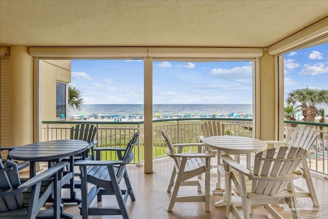 13599 Perdido Key Dr Unit T-2C, Perdido Key, FL 32507 - sunroom / solarium featuring view of water and beach and a textured ceiling