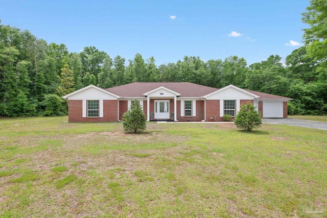 ranch-style home featuring brick siding, a garage, and a front yard