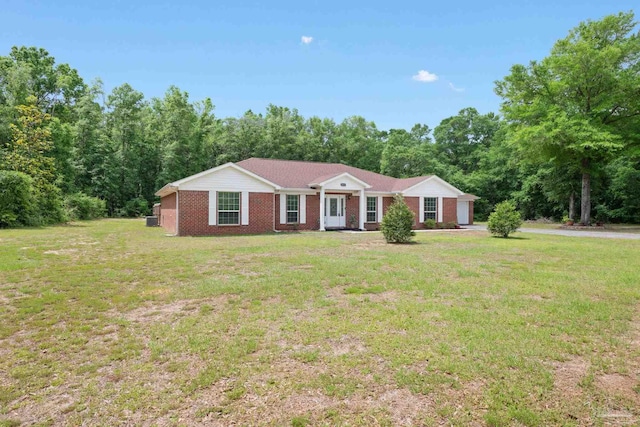 ranch-style home with an attached garage, a front lawn, and brick siding