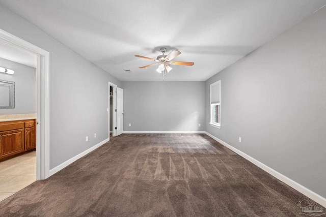 interior space featuring baseboards, ceiling fan, and visible vents