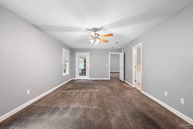 carpeted empty room with baseboards and ceiling fan