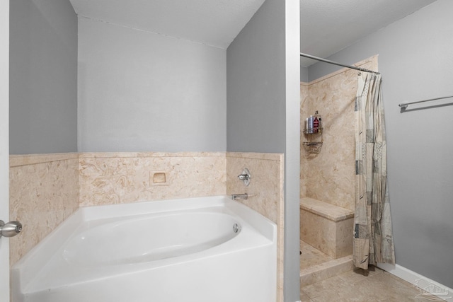 full bath with tile patterned floors, a shower stall, and a garden tub