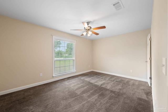 unfurnished room with baseboards, carpet, a ceiling fan, and visible vents