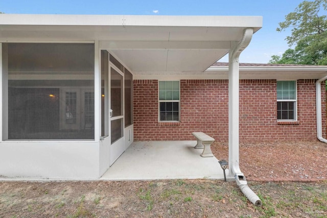 view of patio / terrace featuring a sunroom