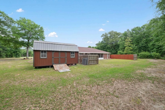 exterior space featuring fence, a storage unit, and an outdoor structure