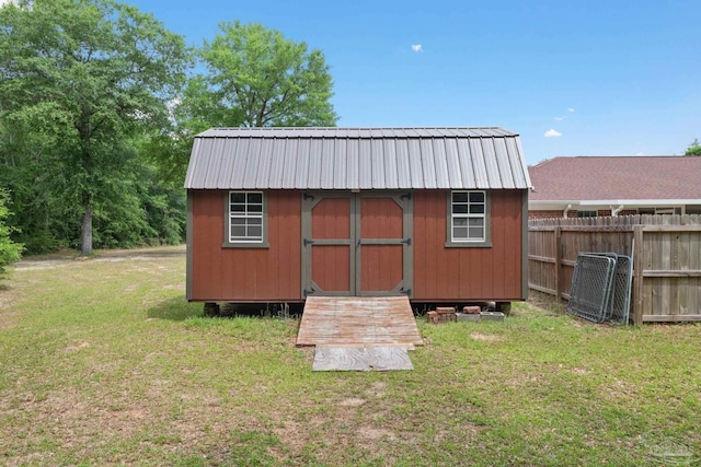 view of shed featuring fence