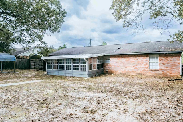 back of house featuring a carport