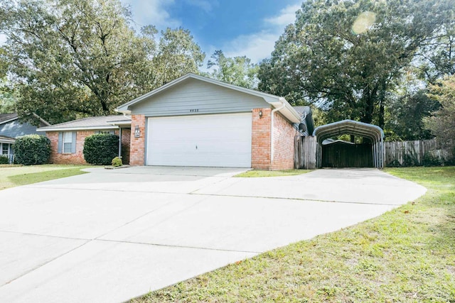 view of front of property featuring a front lawn, a garage, and a carport