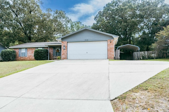 ranch-style house with a front lawn, a garage, and a carport