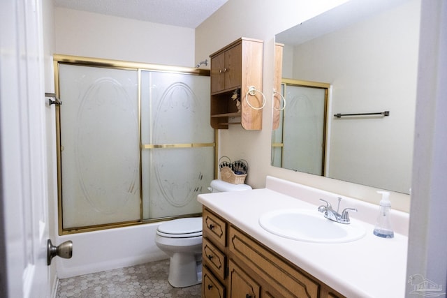 full bathroom featuring tile patterned floors, bath / shower combo with glass door, vanity, a textured ceiling, and toilet