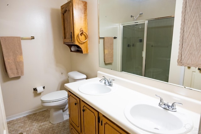 bathroom with tile patterned flooring, vanity, toilet, and walk in shower