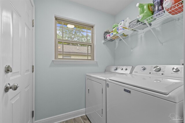 3963 Edgefield St, Pace, FL 32571 - laundry area with washing machine and dryer, baseboards, and wood finished floors