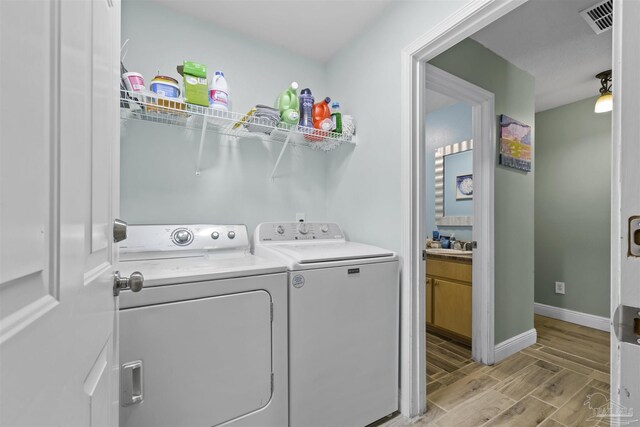 3963 Edgefield St, Pace, FL 32571 - laundry area featuring independent washer and dryer, wood finish floors, and baseboards