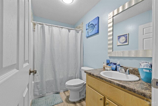 3963 Edgefield St, Pace, FL 32571 - full bath with vanity, wood finished floors, toilet, and a textured ceiling