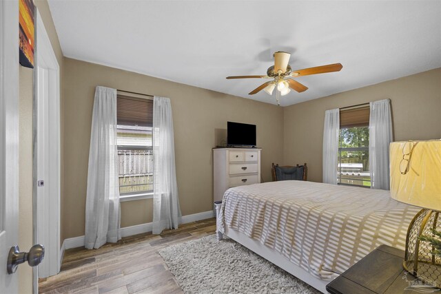 3963 Edgefield St, Pace, FL 32571 - bedroom with wood finished floors, baseboards, and a ceiling fan