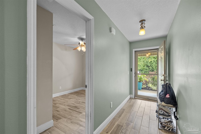 3963 Edgefield St, Pace, FL 32571 - entrance foyer featuring light wood-style floors, baseboards, a textured ceiling, and a ceiling fan