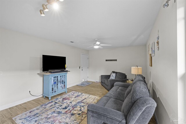 3963 Edgefield St, Pace, FL 32571 - living room featuring light wood finished floors, a ceiling fan, and baseboards