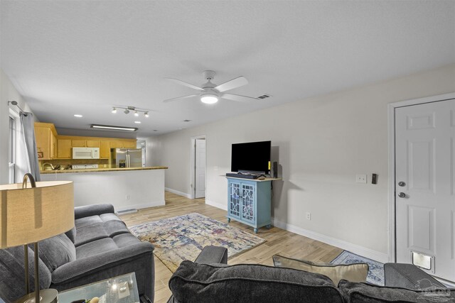 3963 Edgefield St, Pace, FL 32571 - living area with ceiling fan, light wood finished floors, and baseboards