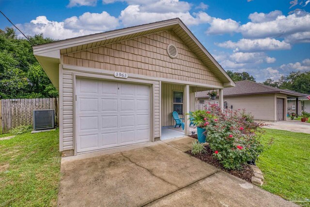 3963 Edgefield St, Pace, FL 32571 - detached garage with concrete driveway, covered porch, and cooling unit