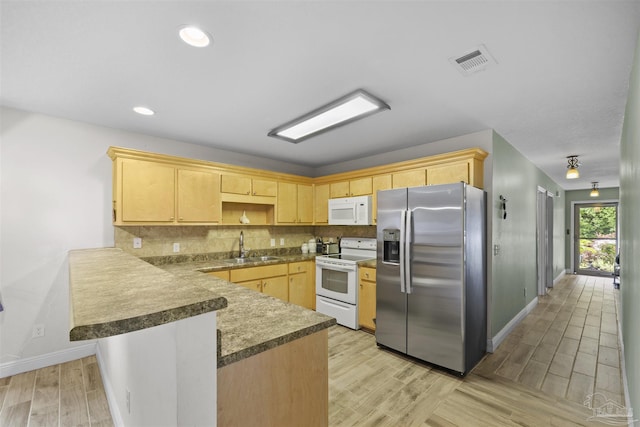3963 Edgefield St, Pace, FL 32571 - kitchen with white appliances, a peninsula, light brown cabinetry, baseboards, and light wood-type flooring