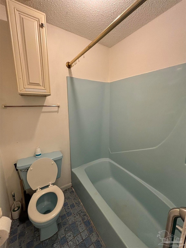 bathroom featuring a textured ceiling, toilet, and  shower combination