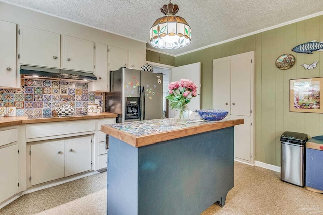 kitchen featuring pendant lighting, white cabinets, black electric cooktop, stainless steel fridge with ice dispenser, and a textured ceiling