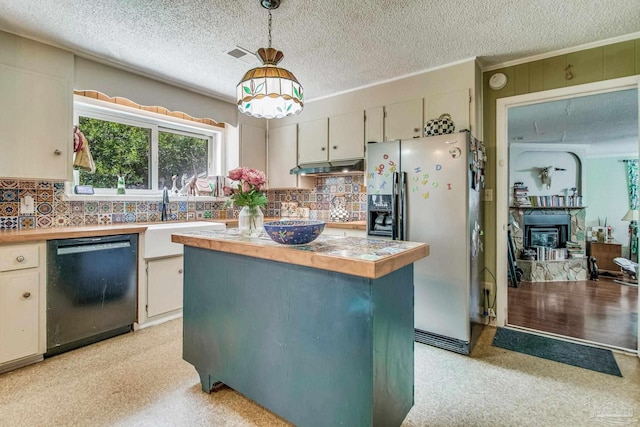 kitchen with sink, a center island, stainless steel fridge with ice dispenser, black dishwasher, and pendant lighting