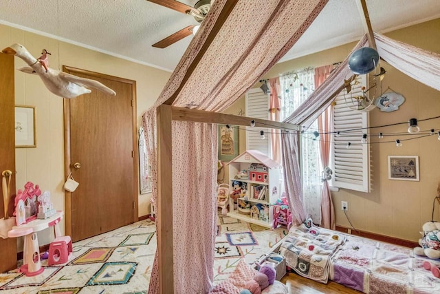 bedroom featuring ceiling fan, ornamental molding, and a textured ceiling