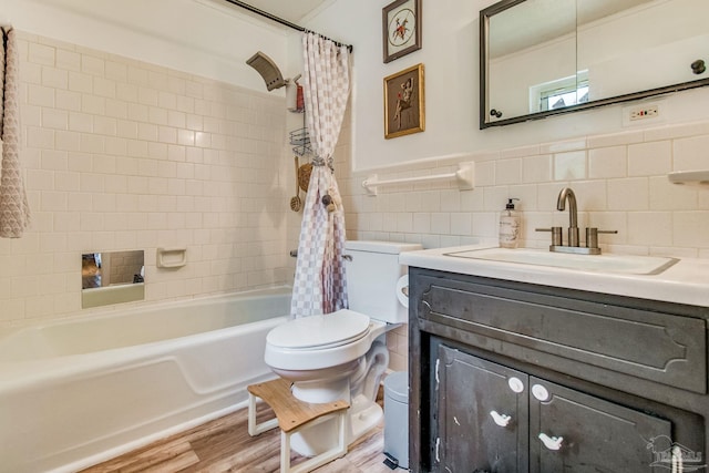 full bathroom featuring hardwood / wood-style flooring, tile walls, vanity, shower / bath combination with curtain, and toilet