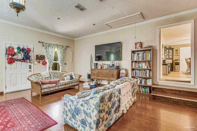 living room featuring hardwood / wood-style floors, crown molding, and a textured ceiling