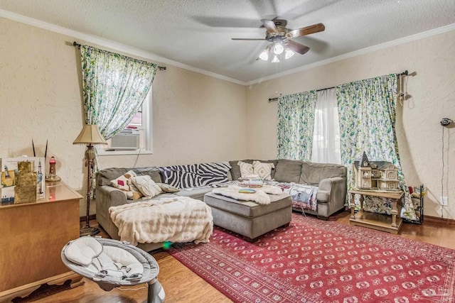 living room with cooling unit, hardwood / wood-style flooring, ornamental molding, and a textured ceiling