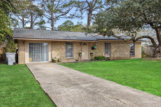 1404 Stanford Rd, Gulf Breeze, FL 32563 - ranch-style home featuring a shingled roof, a front yard, and brick siding
