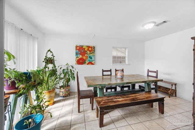 1404 Stanford Rd, Gulf Breeze, FL 32563 - dining room with a textured ceiling, light tile patterned flooring, and visible vents
