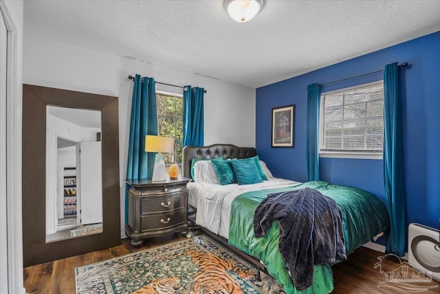 1404 Stanford Rd, Gulf Breeze, FL 32563 - bedroom with a textured ceiling and wood finished floors