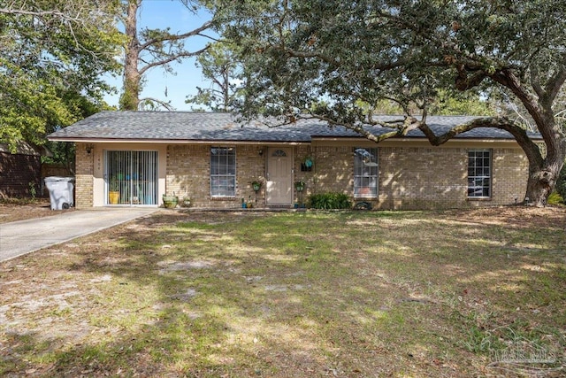 single story home with brick siding and a front lawn