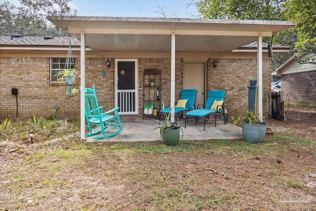 1404 Stanford Rd, Gulf Breeze, FL 32563 - rear view of house featuring a patio and brick siding