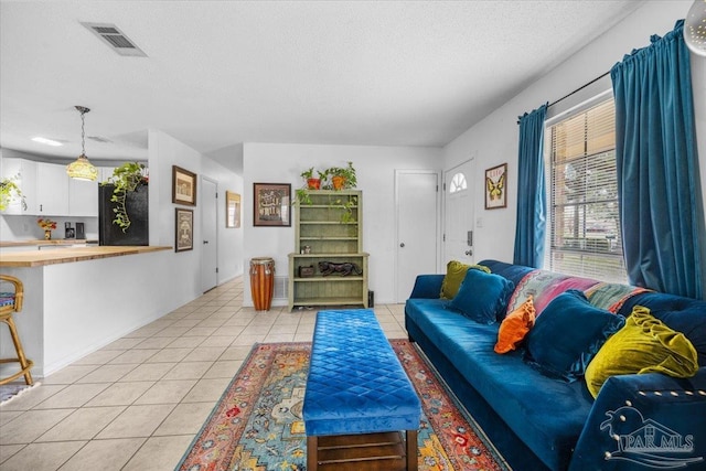 1404 Stanford Rd, Gulf Breeze, FL 32563 - living room featuring visible vents, a textured ceiling, and light tile patterned flooring